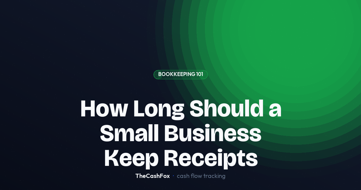 Small business owner organizing paper receipts into a file folder on a desk with a laptop nearby